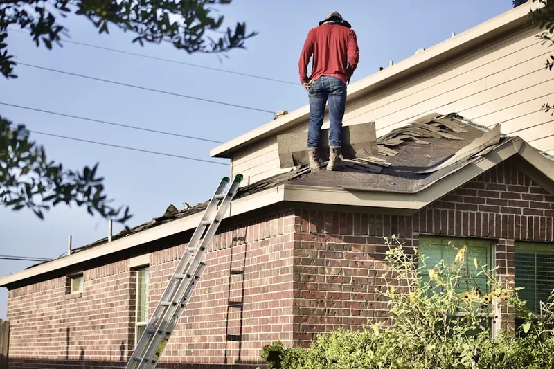 Professional roofer working on a residential roof in Fairburn